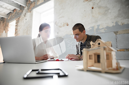 Image of Female estate agent showing new home to a young man after a discussion on house plans, moving, new home concept