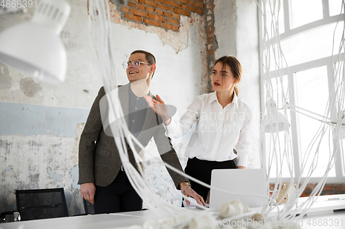 Image of Female estate agent showing new home to a young man after a discussion on house plans, moving, new home concept