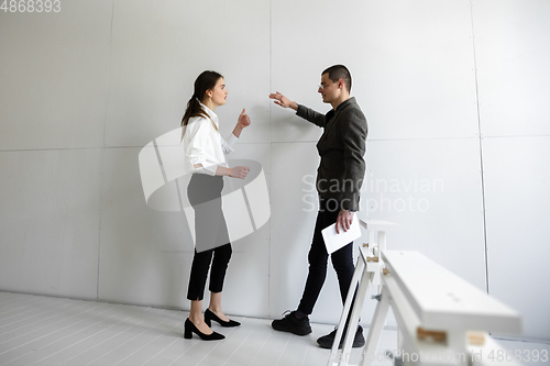 Image of Female estate agent showing new home to a young man after a discussion on house plans, moving, new home concept