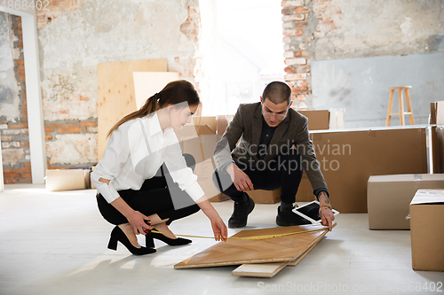 Image of Female estate agent showing new home to a young man after a discussion on house plans, moving, new home concept