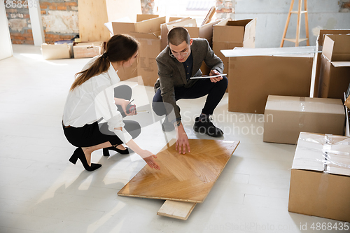 Image of Female estate agent showing new home to a young man after a discussion on house plans, moving, new home concept