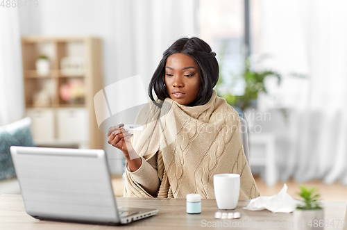 Image of sick woman having video call on laptop at home