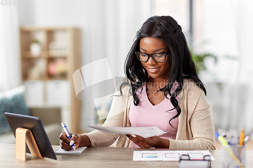 Image of african woman working on ui design at home office