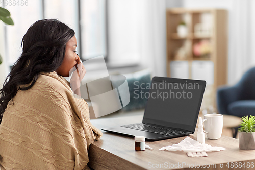 Image of sick woman having video call on laptop at home