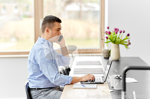Image of man calling on smartphone at home office