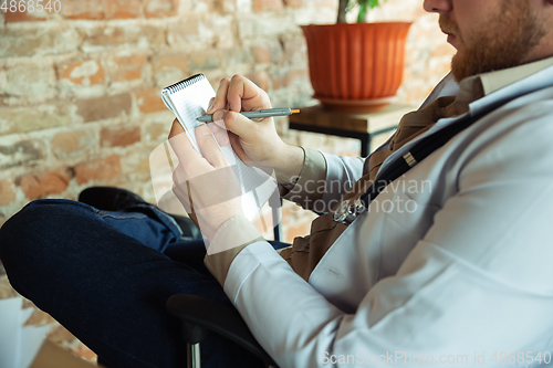 Image of Close up of caucasian doctor consulting for patient, explaining recipe for drug, working in cabinet