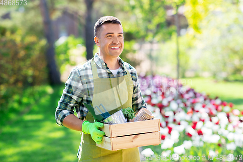 Image of happy man with tools in box at summer garden