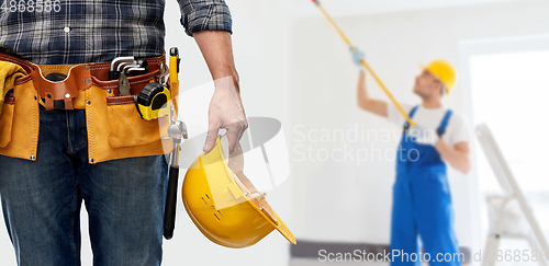 Image of worker or builder with helmet and working tools