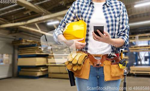 Image of woman or worker with phone and working tools