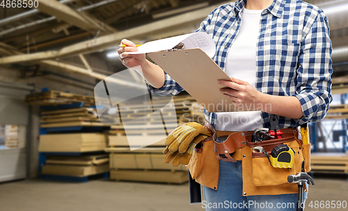 Image of female worker with clipboard and working tools