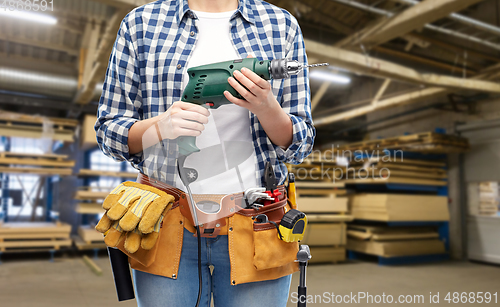 Image of woman or worker with drill and work tools