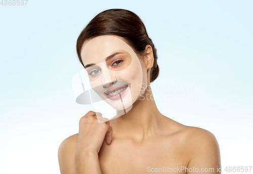 Image of beautiful young woman with hydrogel mask on face