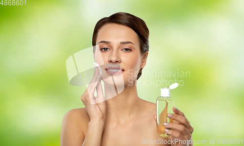 Image of young woman with toner or cleanser and cotton pad