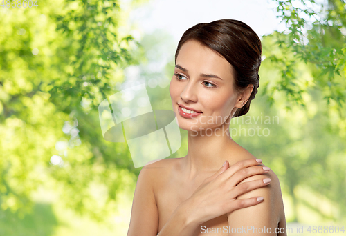 Image of beautiful young woman touching bare shoulder