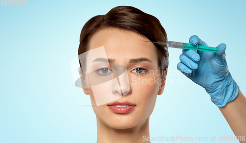 Image of beautiful young woman and hand with syringe