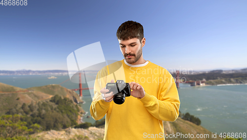 Image of man with camera over golden gate bridge