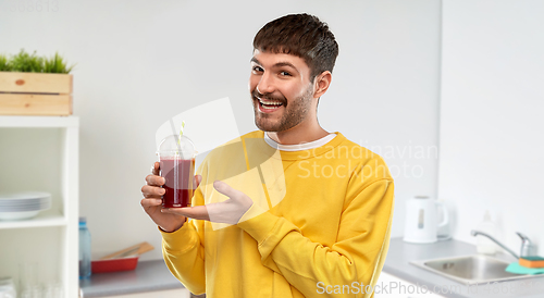 Image of happy man with tomato juice in takeaway cup