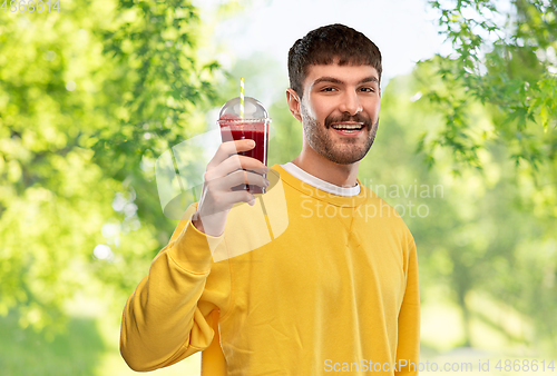 Image of happy man with tomato juice in takeaway cup