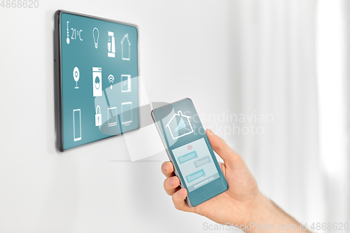 Image of man with smartphone and tablet pc at smart home