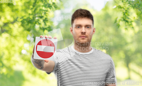 Image of young man showing stop sign