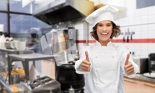 Image of happy female chef showing thumbs up at kebab shop