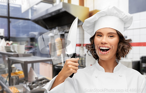 Image of female chef with kitchen knife at kebab shop