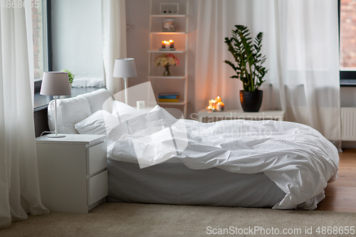 Image of cozy bedroom with white linen on bed