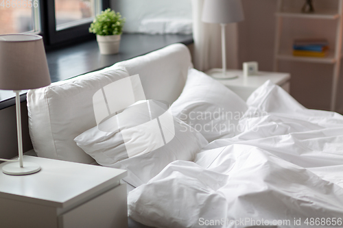 Image of cozy bedroom with white linen on bed