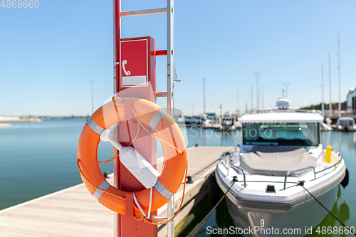 Image of life ring or lifebuoy hanging on post at sea berth