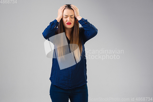 Image of Young woman suffers from pain, feels sick, ill and weakness isolted on studio background