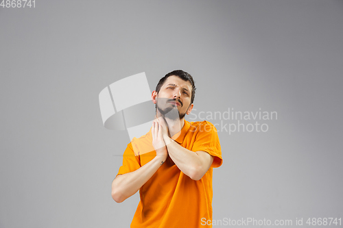 Image of Young man suffers from pain, feels sick, ill and weakness isolted on studio background