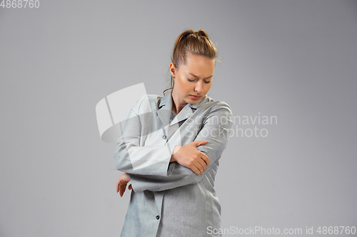 Image of Young woman suffers from pain, feels sick, ill and weakness isolted on studio background