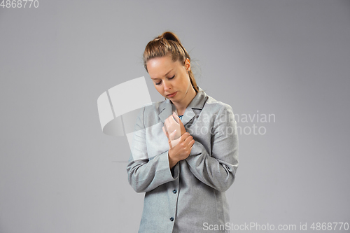 Image of Young woman suffers from pain, feels sick, ill and weakness isolted on studio background