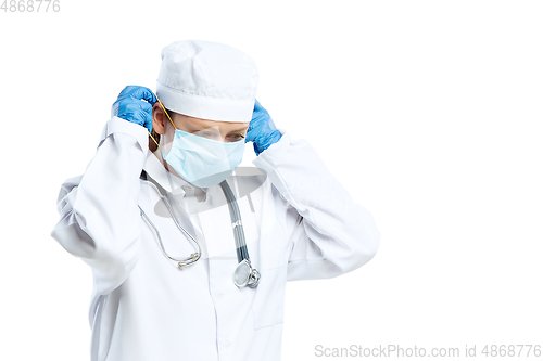 Image of Female young doctor with stethoscope and face mask isolated on white studio background