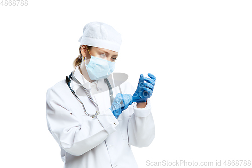 Image of Female young doctor with stethoscope and face mask isolated on white studio background