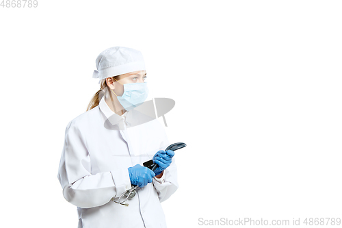 Image of Female young doctor with stethoscope and face mask isolated on white studio background