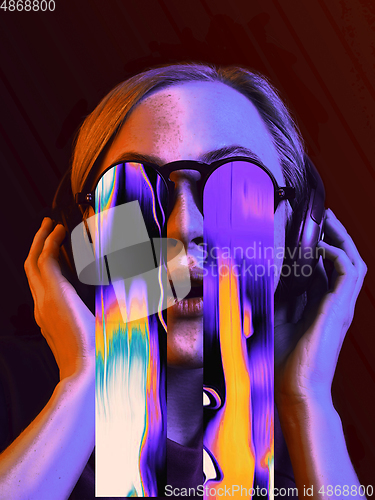 Image of Modern woman\'s portrait on studio background in bright neon light, stylish creative design