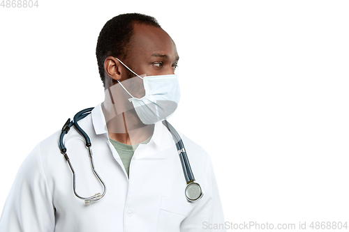 Image of Male young doctor with stethoscope and face mask isolated on white studio background
