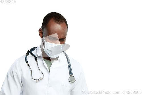 Image of Male young doctor with stethoscope and face mask isolated on white studio background