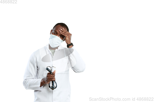 Image of Male young doctor with stethoscope and face mask isolated on white studio background