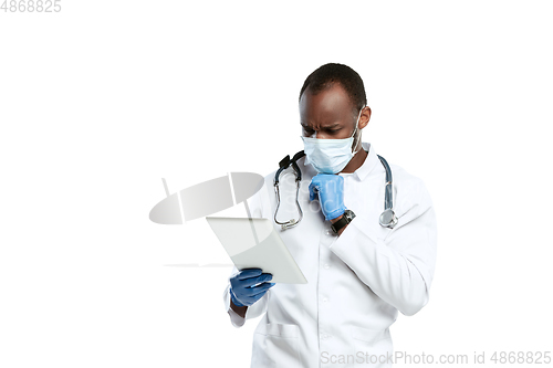 Image of Male young doctor with stethoscope and face mask isolated on white studio background