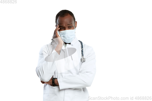 Image of Male young doctor with stethoscope and face mask isolated on white studio background