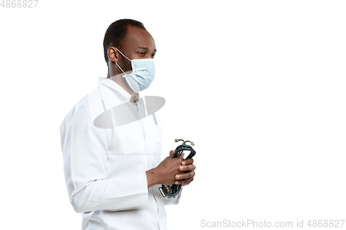 Image of Male young doctor with stethoscope and face mask isolated on white studio background