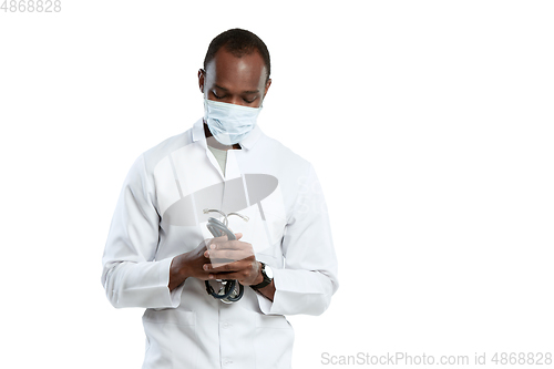 Image of Male young doctor with stethoscope and face mask isolated on white studio background