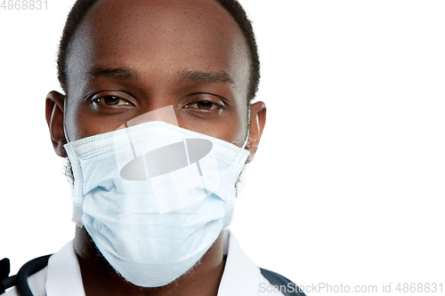 Image of Close up young doctor with stethoscope and face mask isolated on white studio background