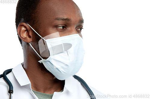 Image of Close up young doctor with stethoscope and face mask isolated on white studio background