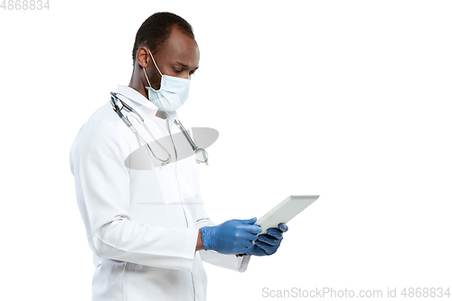 Image of Male young doctor with stethoscope and face mask isolated on white studio background