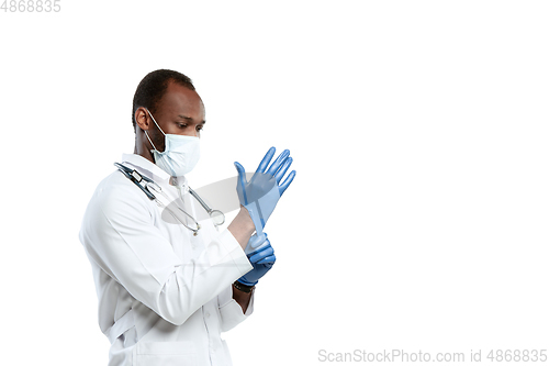 Image of Male young doctor with stethoscope and face mask isolated on white studio background