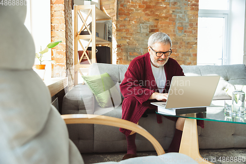 Image of Mature senior older man during quarantine, realizing how important stay at home during virus outbreak