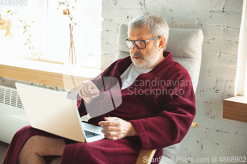Image of Mature senior older man during quarantine, realizing how important stay at home during virus outbreak